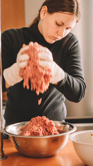 beautiful woman preparing more meat for hamburgers