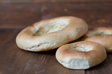 uzbek flatbread white bread is broken into pieces crumbs on a brown background illustration