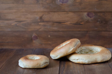 uzbek flatbread white bread is broken into pieces crumbs on a brown background illustration