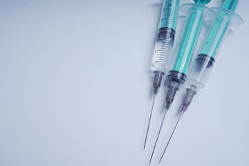 medical disposable syringe with needle for injection in the hospital. medical devices on a white...