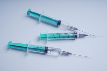 medical disposable syringe with needle for injection in the hospital. medical devices on a white background. virus protection concept