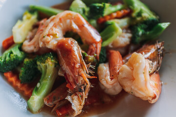 Close up of Thai food Stir Fried Broccoli with Shrimp on white dish.