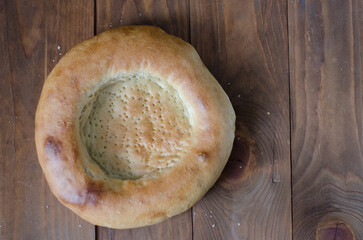 uzbek flatbread white bread is broken into pieces crumbs on a brown background illustration