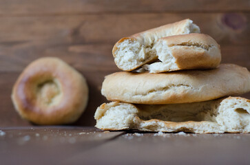 uzbek flatbread white bread is broken into pieces crumbs on a brown background illustration