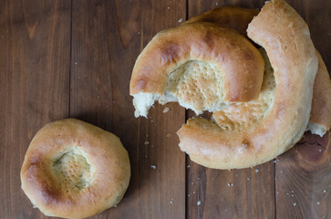 uzbek flatbread white bread is broken into pieces crumbs on a brown background illustration