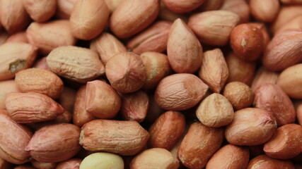 Salted Roasted Peanuts, Peeled raw peanuts are in a plastic cup, Healthy content, Copy space, top view.