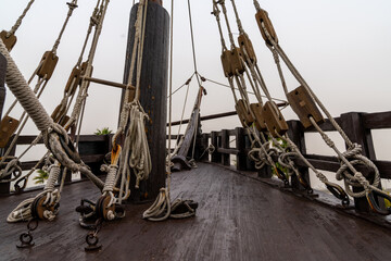 ropes and mast of an old wooden sailing ship in detail