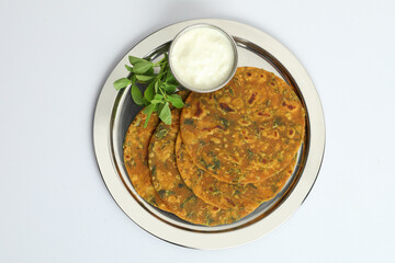 Indian flat bread,Methi Paratha,an Indian flatbread stuffed with fenugreek leaves and spices served with yogurt in breakfast or brunch 