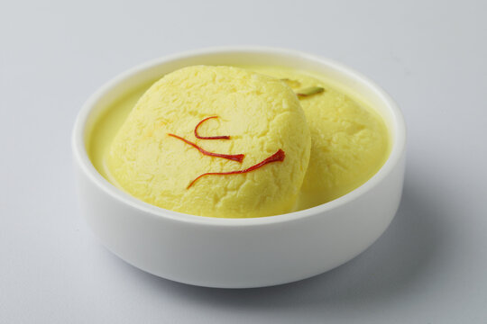 Rasmalai is an Indian dessert sweet with dry fruits and Saffron toppings, served in a bowl . selective focus