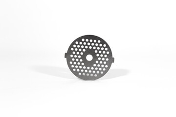 
Metal mesh for electric meat grinders. Made of high carbon magnetized stainless steel. Heat treatment. Resistant to wear and corrosion. Fine lattice. White background.