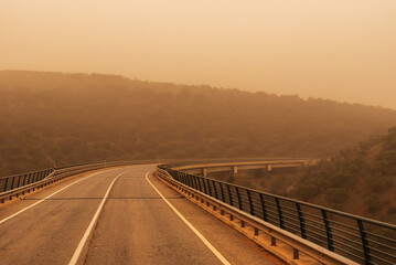 Viaduct between mountains with a lot of saharan dust in the environment (calima)