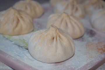 The process of cooking meat khinkali side view.