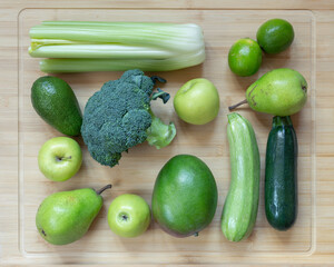 Top-down view to flat lay green vegetable composition with celery broccoli apple pear zucchini
