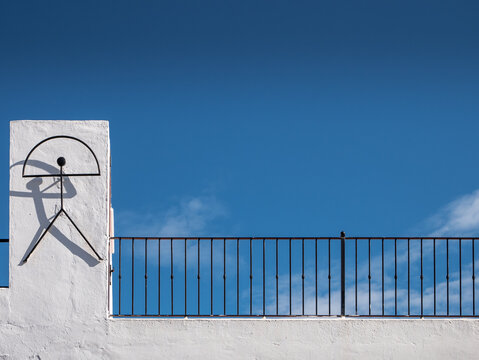 Traditional Indalo symbol on a wall with blue sky in the background in Mojacar, Almeria, Andalusia, Spain