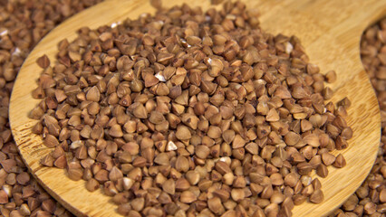 Buckwheat in a wooden spatula. Close up. Background.