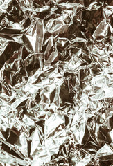 Silver brown white crumpled foil metallic luster texture background

