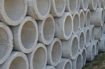 large concrete sewer pipes lined up on the ground