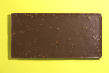 Square chocolate bar. On a yellow background.