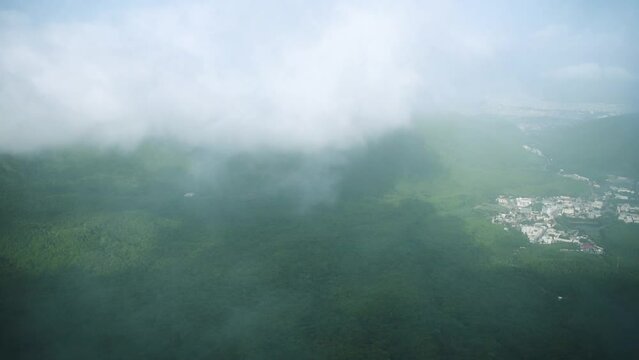 Beautiful view of Clouds cover green mountains and Junagadh city, View from Girnar hills. Foggy  mountain valley during Monsoon season. Ecology and environment conservation