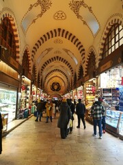 People are shopping in the Grand Bazaar in Istanbul.  A shopping center with decorative architecture, a mall with shops. 