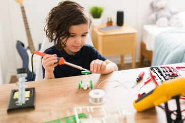 Smart little boy working on his homework