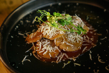 Haute cuisine dish, bulls testicles with tomato, cheese and herbs.