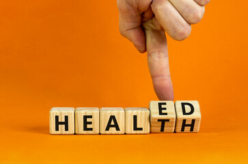 Healed health symbol. Doctor turns wooden cubes and changes concept words Healed to Health....