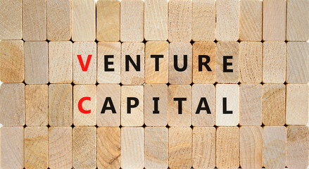 VC venture capital abbraviation symbol. Concept words VC venture capital on wooden blocks on a beautiful wooden background, copy space. Business and VC venture capital concept.