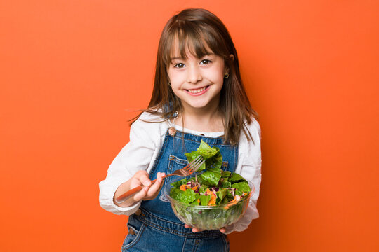 Cute Little Girl Eating A Healthy Salad