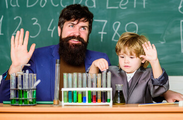 Teacher and child test tubes. Perseverance pays off. Chemical experiment. Symptoms of ADHD at school. Schoolboy cute child experimenting with liquids. School lesson. Educational school program