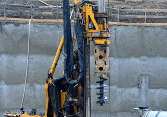 the drilling rig with a pipe drill drills holes for concreting the foundation columns and grouting...