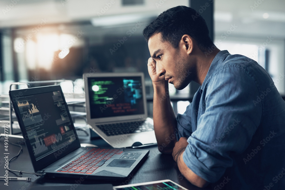 Aufkleber Lifes a game with no reset on the end. Shot of a young man suffering from a headache while using a laptop in a modern office.
