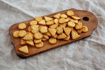 Homemade Salty Crackers on a Rustic Wooden Board, side view.