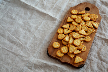 Homemade Salty Crackers on a Rustic Wooden Board, low angle view. Copy space.