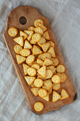 Homemade Salty Crackers on a Rustic Wooden Board, top view. Flat lay, overhead, from above.
