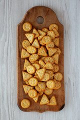 Homemade Salty Crackers on a Rustic Wooden Board, top view. Flat lay, overhead, from above.