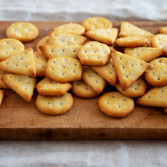 Homemade Salty Crackers on a Rustic Wooden Board, side view. Close-up.