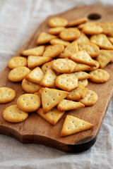 Homemade Salty Crackers on a Rustic Wooden Board, side view. Close-up.