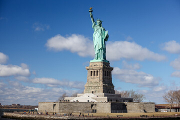 Fototapeta premium The Statue of Liberty in New York against a blue sky