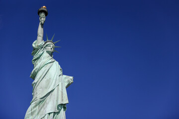 Obraz na płótnie Canvas The Statue of Liberty in New York against a blue sky