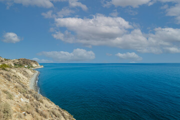 Obraz premium Summer landscape of Crete island in Greece in Europe. Coast in the Larapetra region. In the background is a sunny sky with clouds.