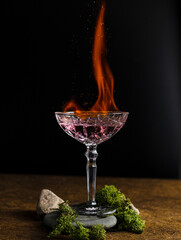 Burning alcohol cocktail, fire in glass