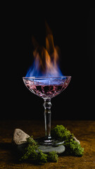 Burning alcohol cocktail, fire in glass