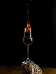 Burning alcohol cocktail, fire in glass