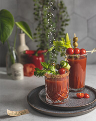 Tomato juice Bloody Mary cocktail topped with vegetables and olives