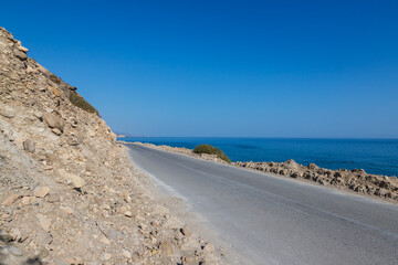 Summer landscape of Crete island in Greece in Europe. Coast in the Larapetra region. In the background is a sunny sky with clouds.