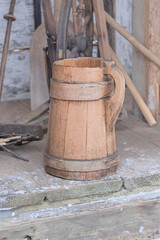 Naklejka premium Old wooden dishes. Authentic kitchenware in the house of a poor peasant in the rustic style. Installation in museums of traditional rural household items.