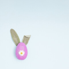 Easter egg with bunny ears. Flat lay. Minimal concept..