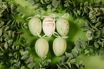 Green easter eggs on a green background. Egg with the inscription 