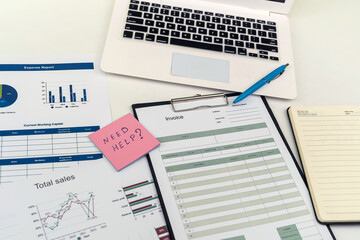 business analyzing investment charts with laptop pen on desk